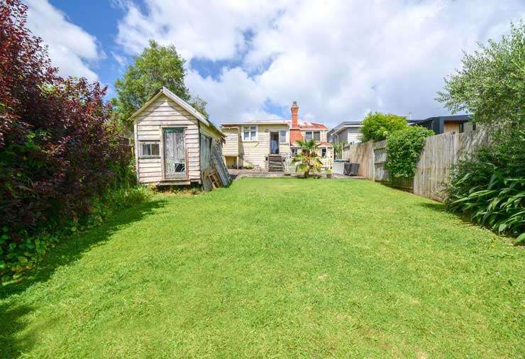 white bay front villa with hedge and picket gate at 17 Harcourt Street, Grey Lynn, Auckland