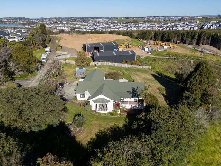 On the market for sale, with its three neighbours, is 240 West Hoe Heights, in Orewa. Earthworks for a housing development can be seen in the background. Photo / Supplied