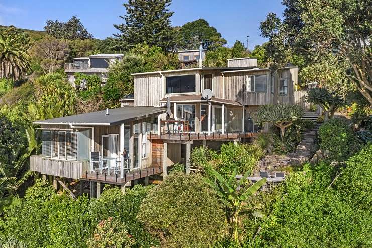 Beachfront properties in Whale Bay like this one at 808B Wainui Road are rare and extremely tightly held. Photo / Supplied