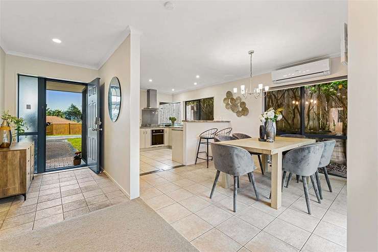 brick and tile house with blue garage door and sunset  14 Ginders Drive Massey