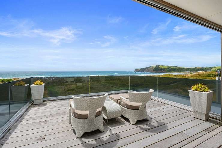 Modern cedar cube house with palm tree sand dunes sea  6 Kutai Lane, Omaha, Auckland