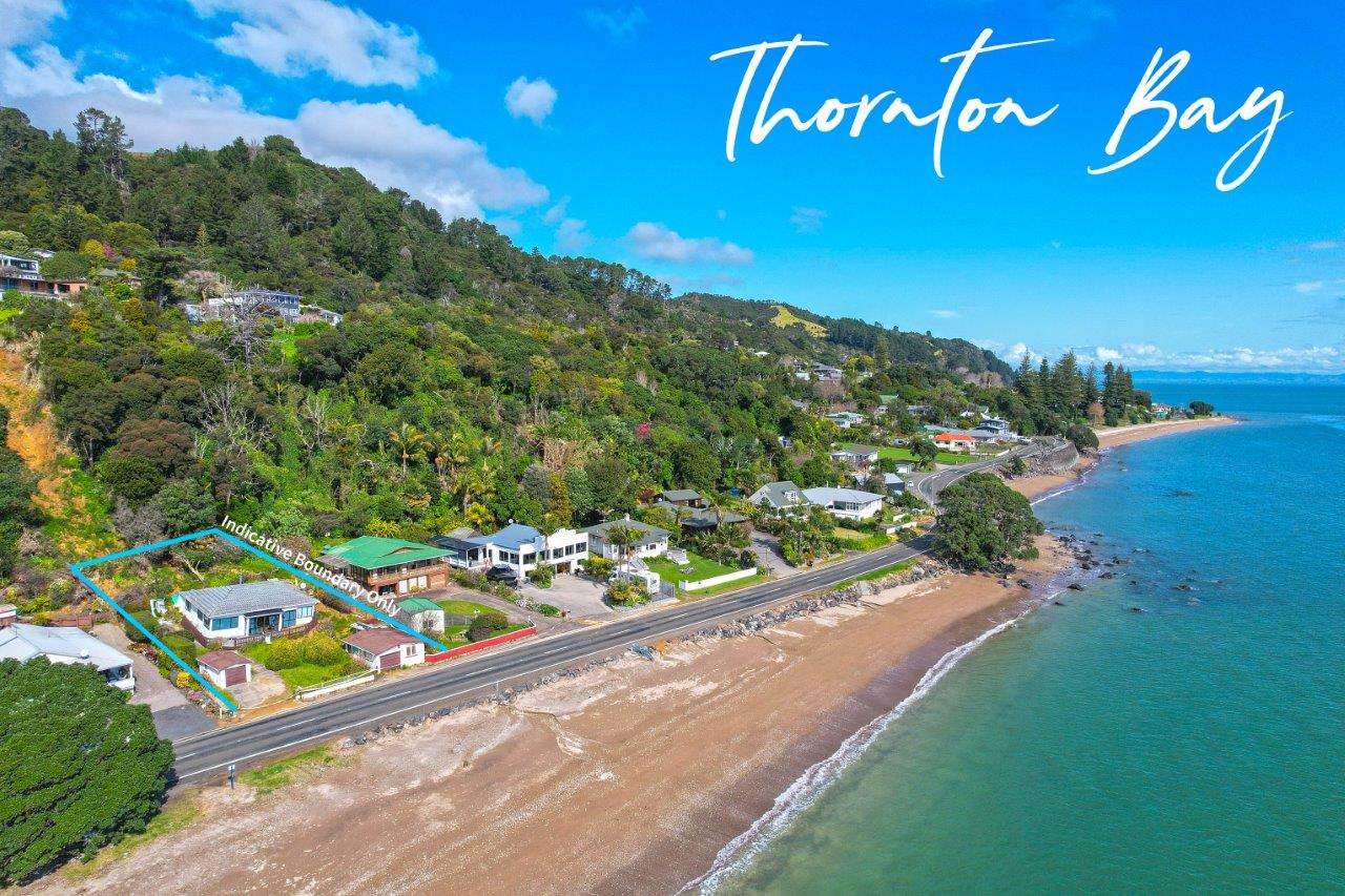 People travelling along the Thames-Coast Road can't miss the eye-catching hoarding outside the crumpled home in Thornton Bay. Photo / Supplied