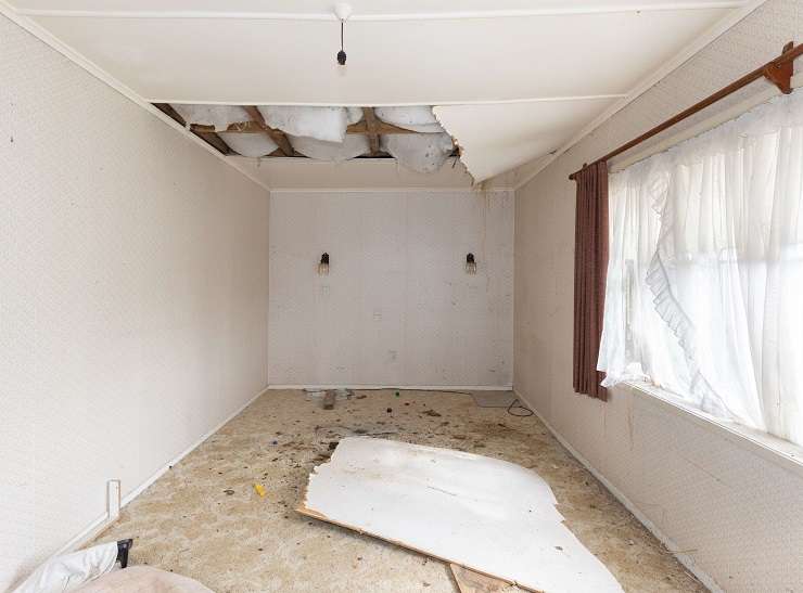 A do-up villa for sale on Harris Street, in Huntly, was filled with rubbish and had what appeared to be mould on the ceilings. Photo / Supplied