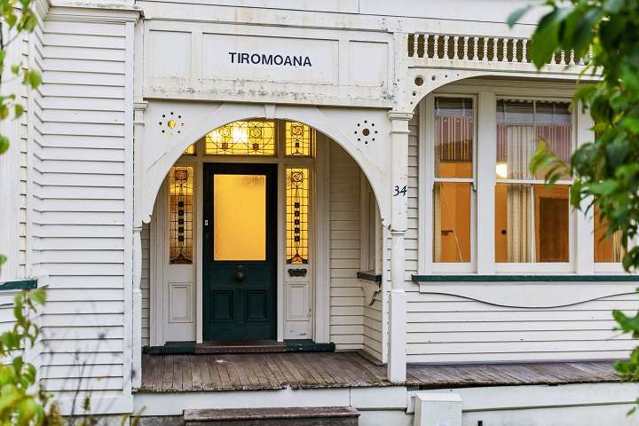 two storey white villa with green roof  34 Bassett Road, Remuera, Auckland