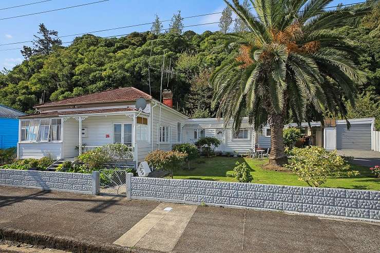 The 100-year-old cottage at 543 Tararu Road is to be auctioned with an advertised reserve of $380,000, which is <img5,000 less than its land value. Photo / Supplied