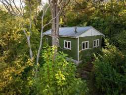 Hut owned by NZ’s ‘greatest painter’ for sale - will secrets inside send price sky high?