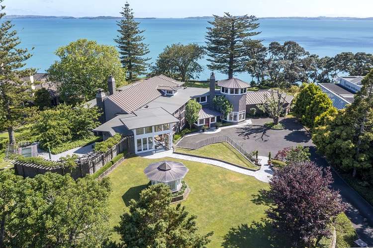 1 Marine Parade Mellons Bay east Auckland   White mansion on lawns above tree-covered cliffs and sea