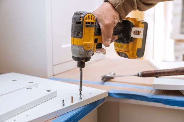 Man tiling bathroom floor