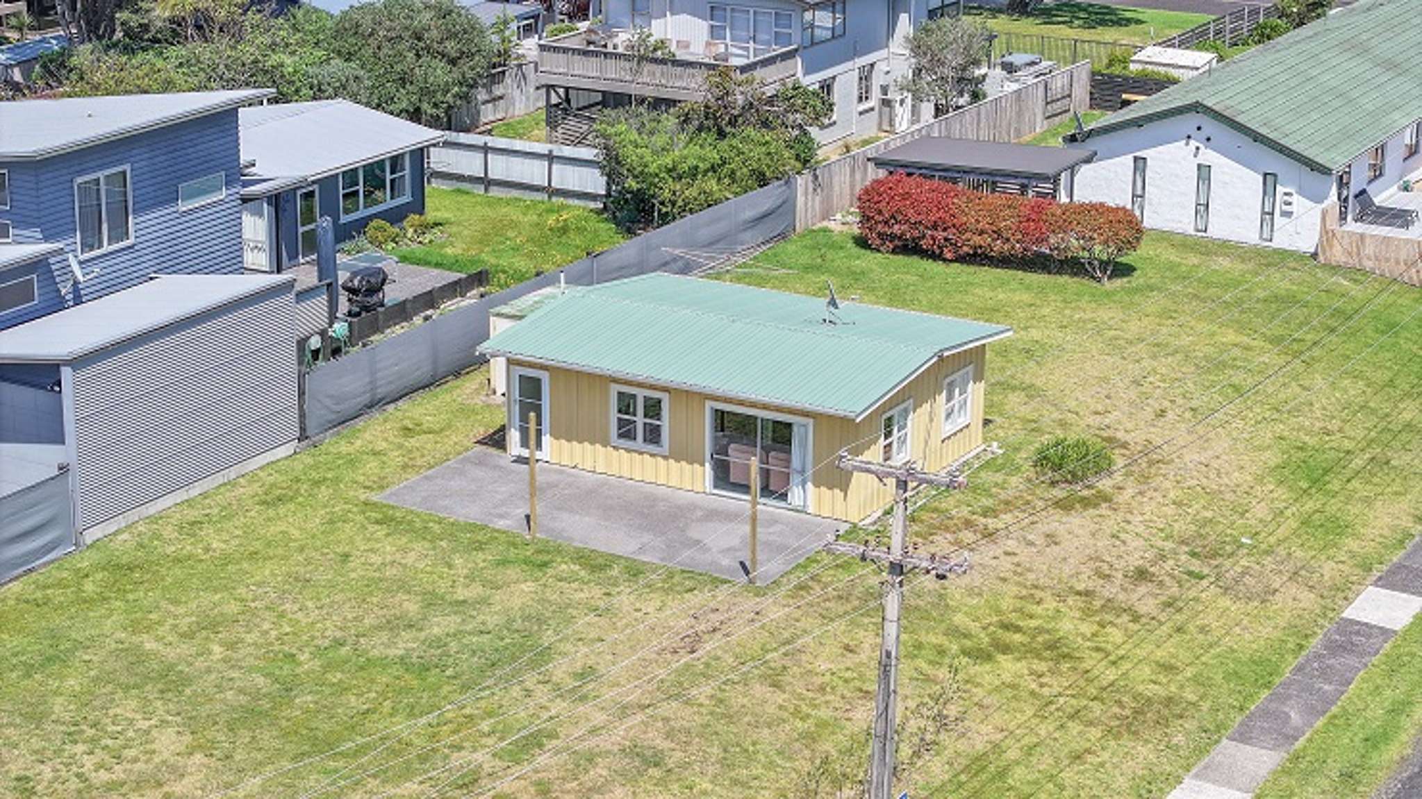 ‘Untouched’ tiny bach on big Whangamatā section sells for $1.675m