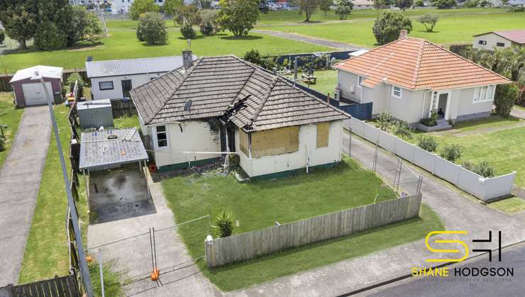 A three-bedroom fire-damaged home at Roscommon Road, in Clendon Park, Auckland, goes to auction at the end of the month with a <img reserve. Photo / Supplied