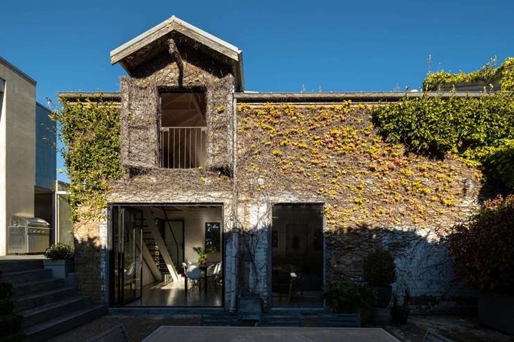 1 Albany Road, in Auckland's Herne Bay, is a modern concrete house that shares its grounds with a heritage brick stable. It is back on the market after three years. Photo / Supplied