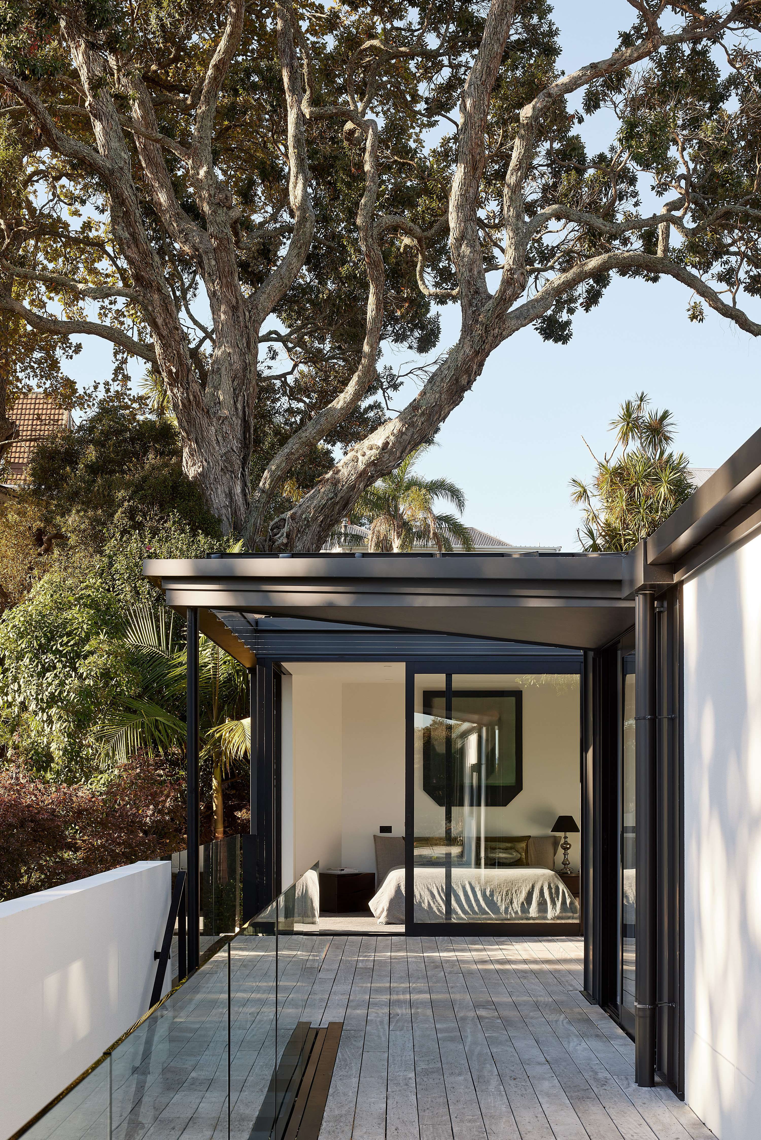 The joinery in Duratec Matt Black (including these APL Architectural Series stacker sliding doors and Metro Series clerestory windows) blends beautifully with the landscape. Photo / supplied.