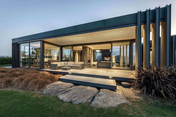 The architecturally designed home is in a much sought-after spot overlooking Lake Hayes, in Queenstown. Photo / Supplied