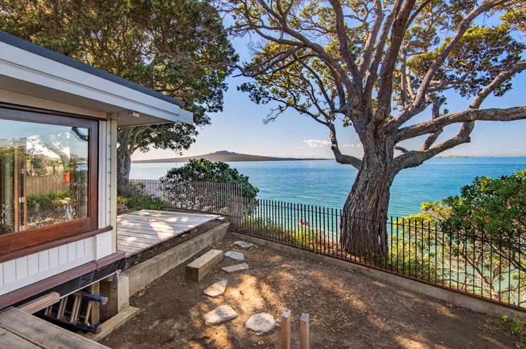 bungalow house on beach with brown fence 48 Cheltenham Road, Cheltenham Beach, Devonport, North Shore