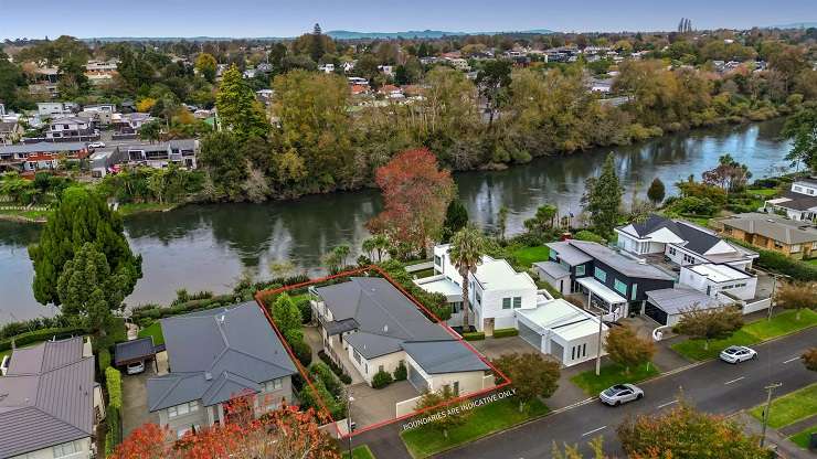 A house on a cross-lease section is one of the cheaper river view properties to sell on one of Hamilton's best streets. Photo / Supplied