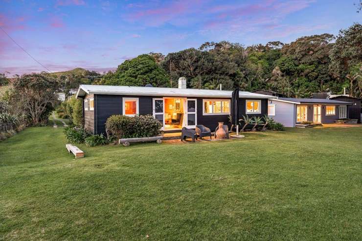 A three-bedroom Lockwood bach at 806 Takatu Road, in Tāwharanui, is one of just a handful still left on the peninsula. Photo / Supplied