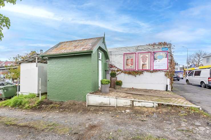 Green brick shed with pink poster on wall  1A Tuarangi Road, Grey Lynn, Auckland