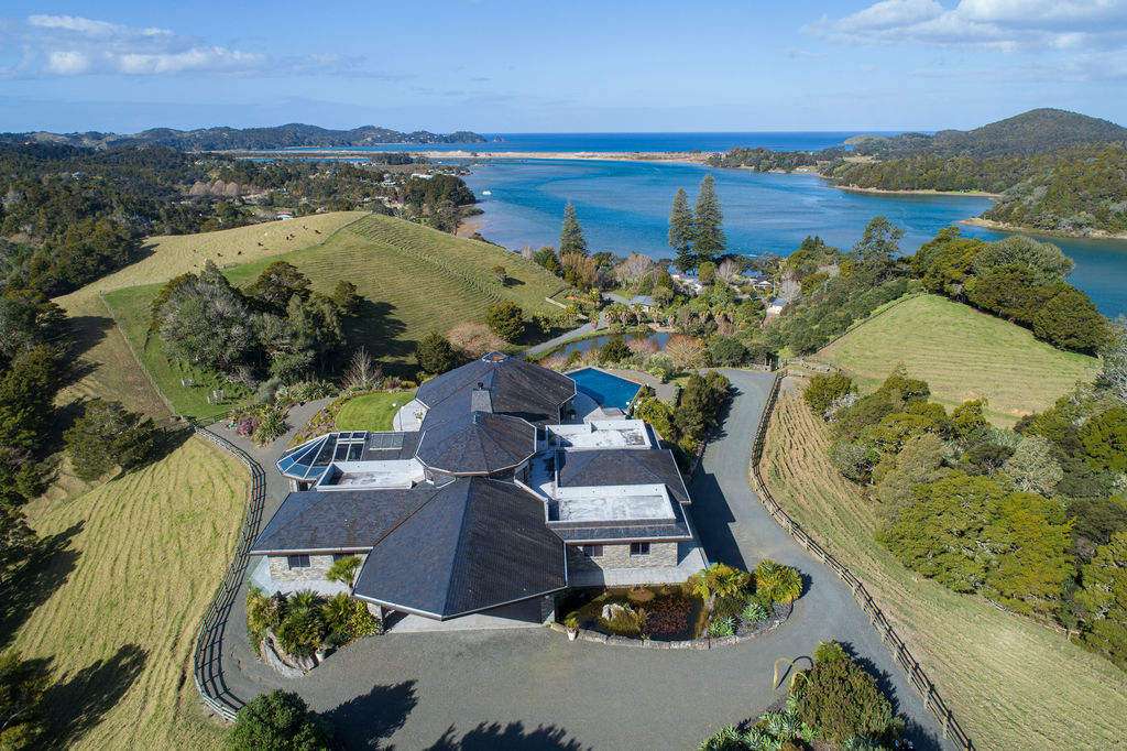 luxury concrete house with trees and mountain behind  10 Pinnacle Place, Queenstown