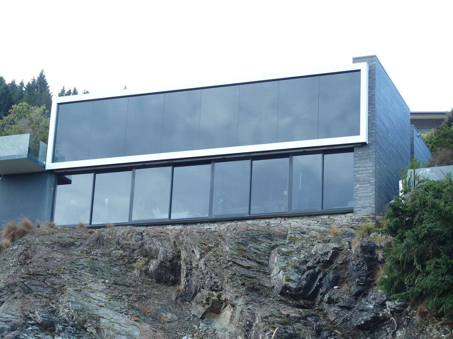 glass and stone luxury lodge above Lake Wakatipu Queenstown