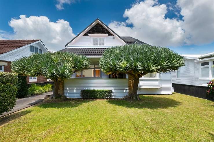 a white bungalow with hedge and lawn on 19 Platina Street, Remuera, Auckland