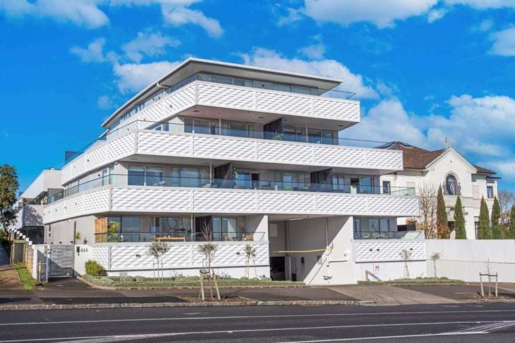 The units are in the Westwood Park apartment development, on Westward Ho Road, in Auckland's Glen Eden. The listing photos for the units show only the exterior covered in scaffolding. Photo / Supplied