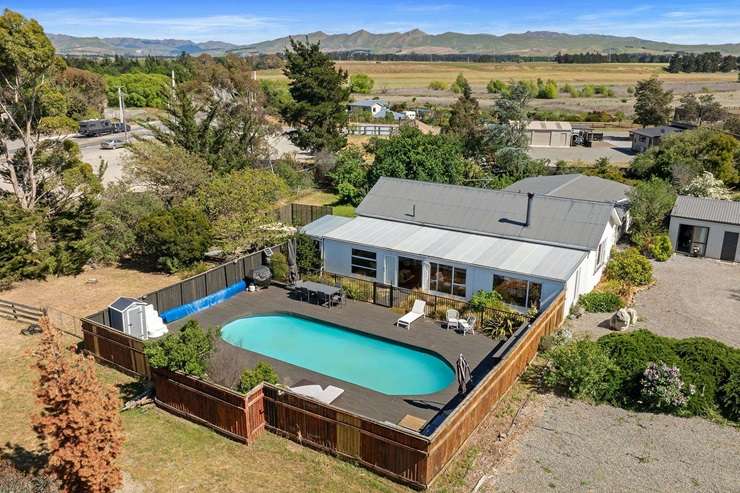 A renovated 1950s home and a quirky train accommodation business, Waipara Sleepers, is seeking buyer enquiry over $995,000. Photo / Supplied