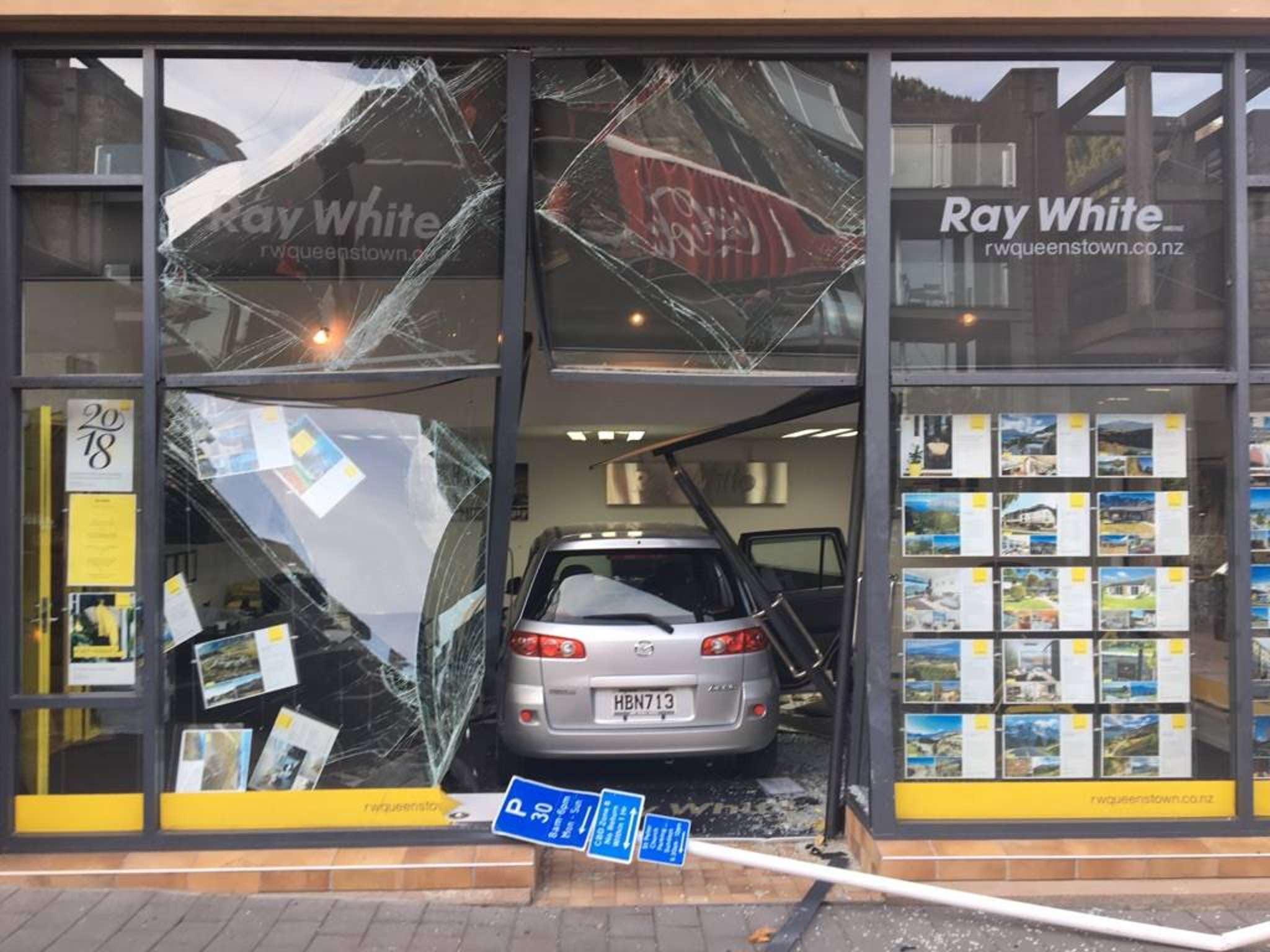 Car ploughs through Ray White Queenstown shop front