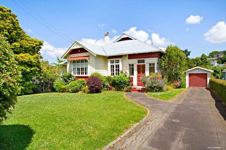 Grey and white bungalow with shingles and leadlight windows 61 Balmoral Road, Mount Eden