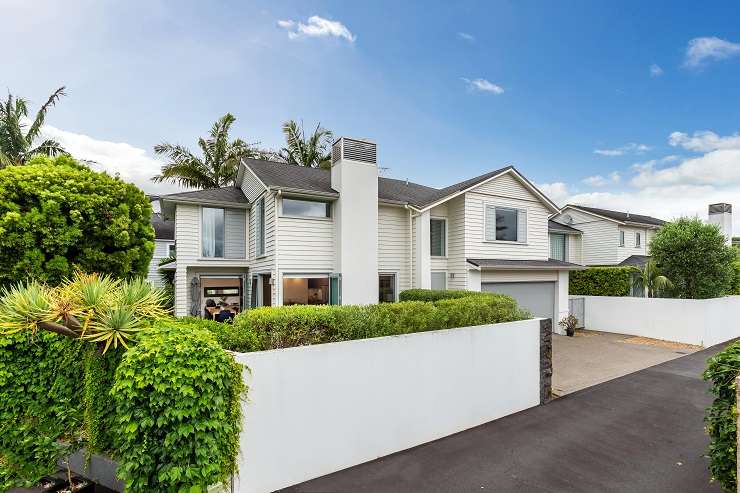 a white bungalow with hedge and lawn on 19 Platina Street, Remuera, Auckland