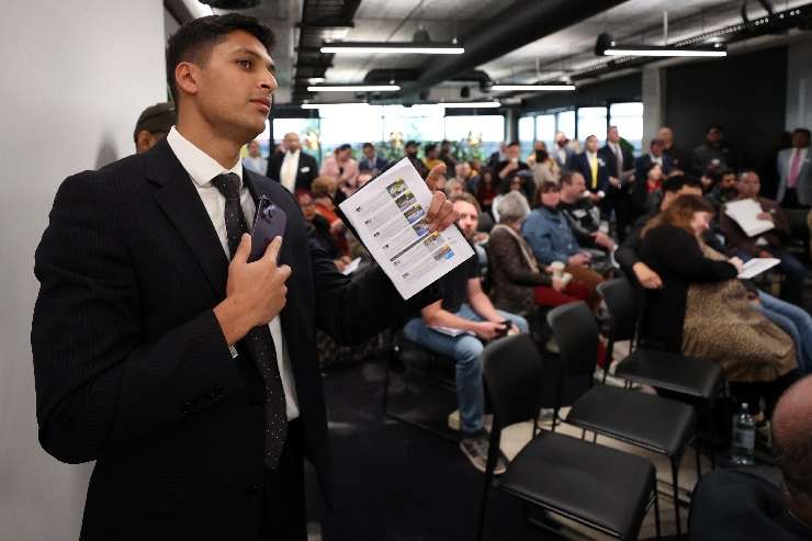 Ray White chief auctioneer Sam Steele takes bids at the agency's mega-auction in South Auckland in July. Photo / Fiona Goodall