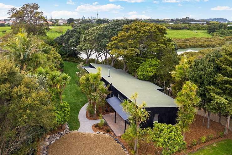 black house with lights on and trees  32 Seacombe Road, Point Chevalier, Auckland