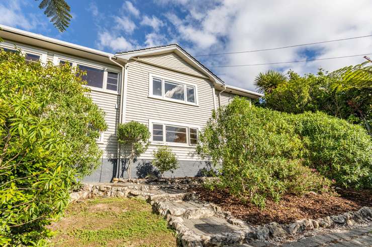 A three-bedroom home partially built from an old train carriage is on the market at 4 Driver Street, in Long Beach, Dunedin. Photo / Supplied