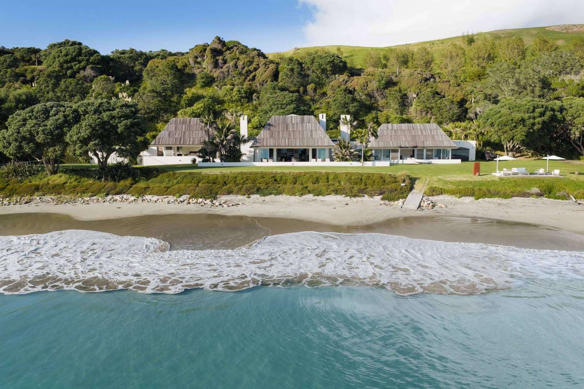 Luxury beachfront enclave with four homes, landscaped gardens and a Pacific vibe for sale