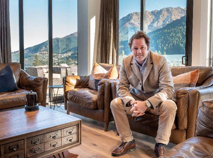 The strip of flat rural land that Queenstown officials are weighing up rezoning can be seen in the centre of the pic, with Lake Hayes in the foreground and lake Wakatipu in the background. Photo / Getty Images