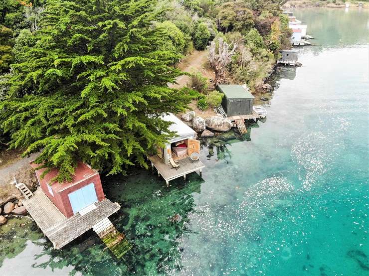 wooden boathouse on deck above water Bay Road Purakaunui north of Dunedin