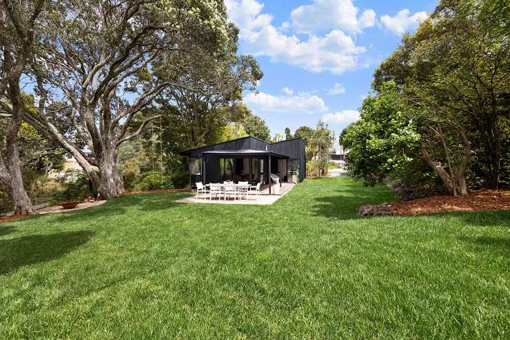 black house with lights on and trees  32 Seacombe Road, Point Chevalier, Auckland