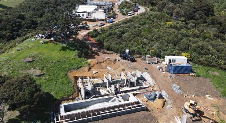 Builders at work on one of the architectural wonders in Waiheke Island's hidden neighbourhoods. Photo / Herbst Architects