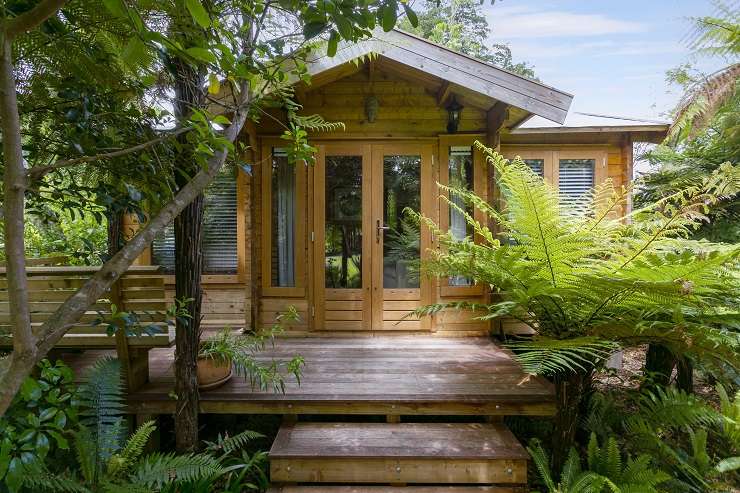 The three-bedroom, two-bathroom home at 23 Humu Street, in Tokaanu, has direct access to a stream and its own geothermal hot tub. Photo / Supplied