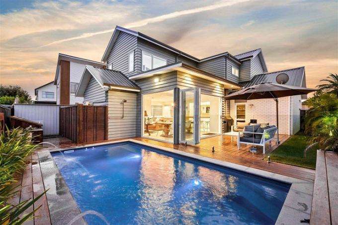 a grand house with portico on Fennell Crescent, Millwater, Auckland's North Shore