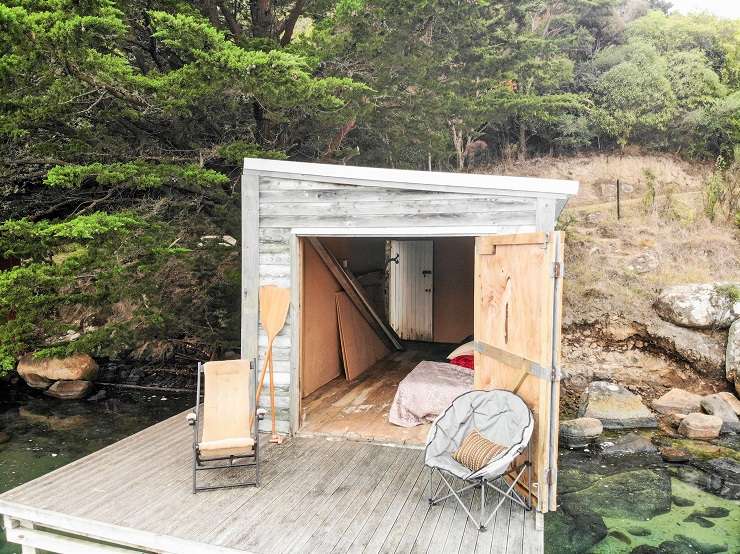 wooden boathouse on deck above water Bay Road Purakaunui north of Dunedin