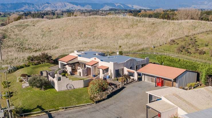 The three-bedroom home for sale at 15 Waitarere Beach Road, in Waitarere, has 