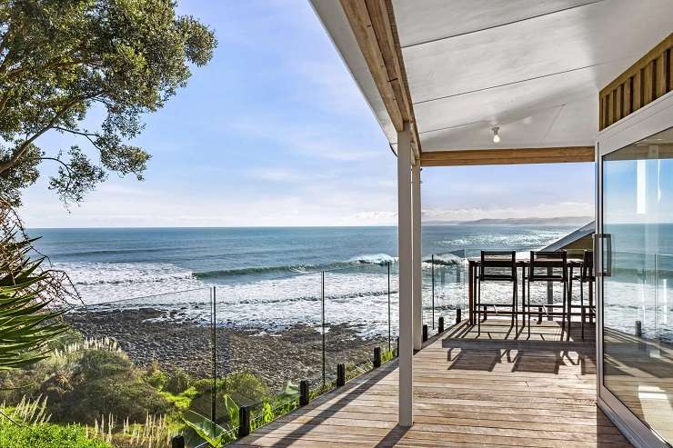 The two-bedroom Wainui Road home, which is one of 10 properties in sought-after Whale Bay, sold for $3m plus. Photo / Supplied