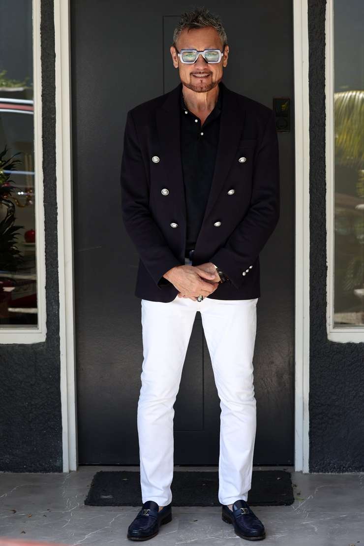 Barfoot & Thompson agent Paul Neshausen is wearing a Dolce & Gabbana sequin suit, a Versace shirt and Gucci shoes. Photo / Fiona Goodall