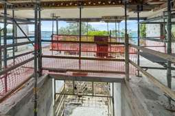 Waterfront ‘beauty and the beast’: Clifftop wreck for sale as mega mansion lists next door