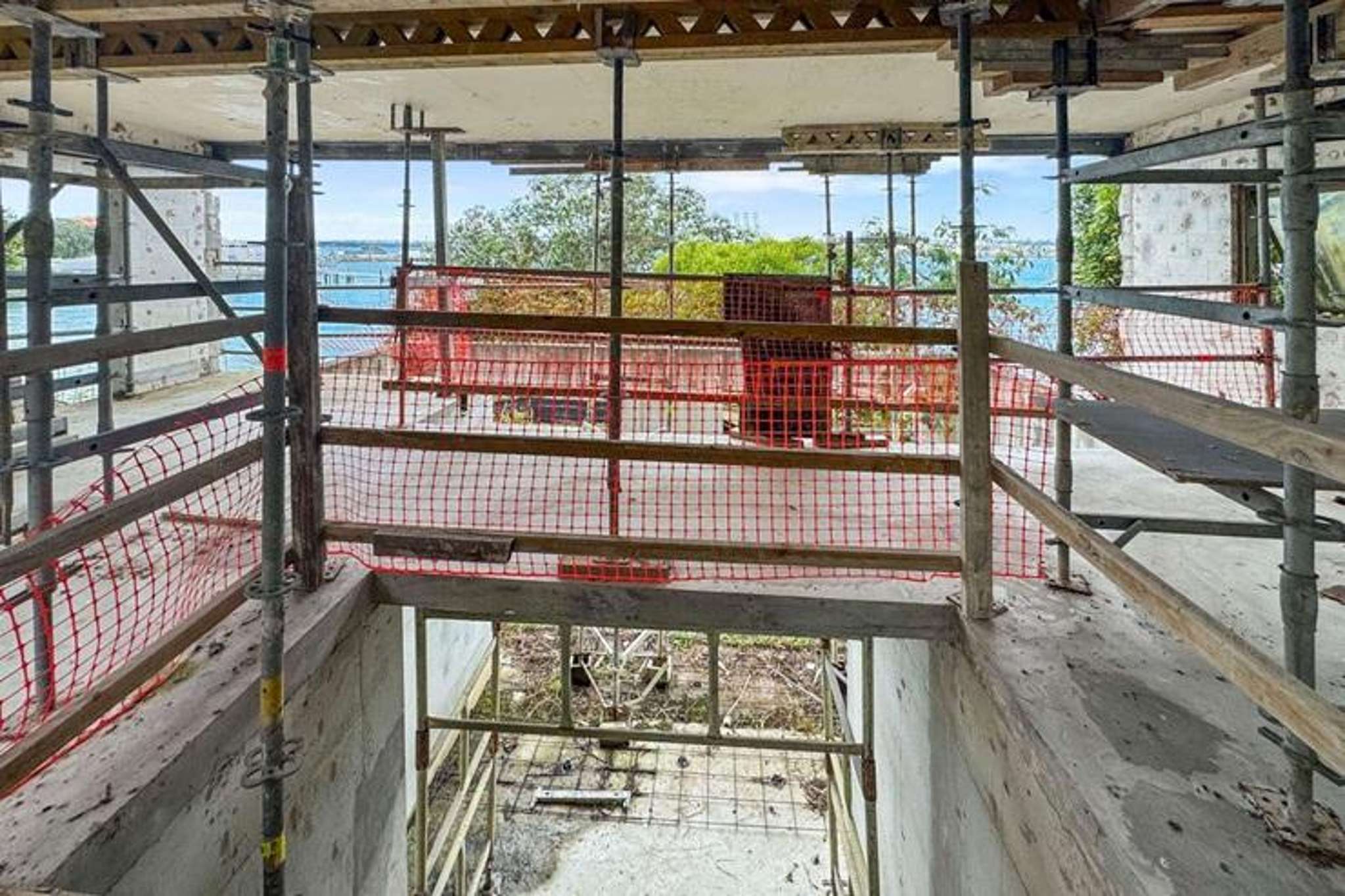 Waterfront ‘beauty and the beast’: Clifftop wreck for sale as mega mansion lists next door