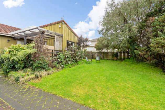 white weatherboard house with green lawn 8 Antsy Place, Mangere, Auckland