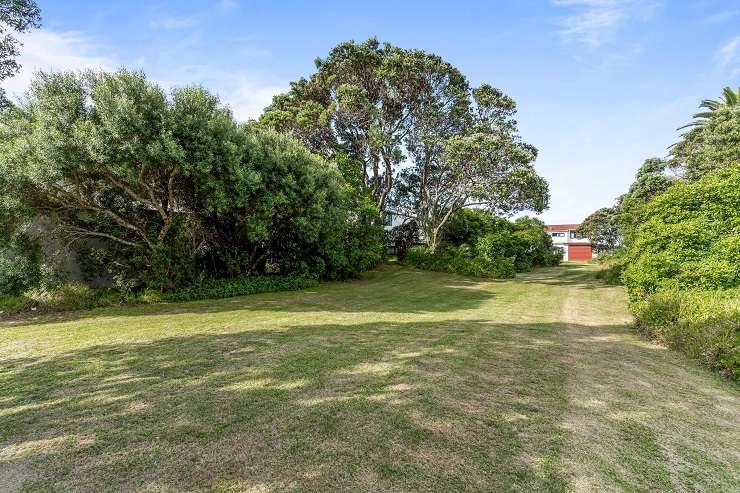 A four-bedroom home on Esplanade Drive, just across from Whangamata Beach, and the section behind it have sold after a deadline process. Photo / Supplied