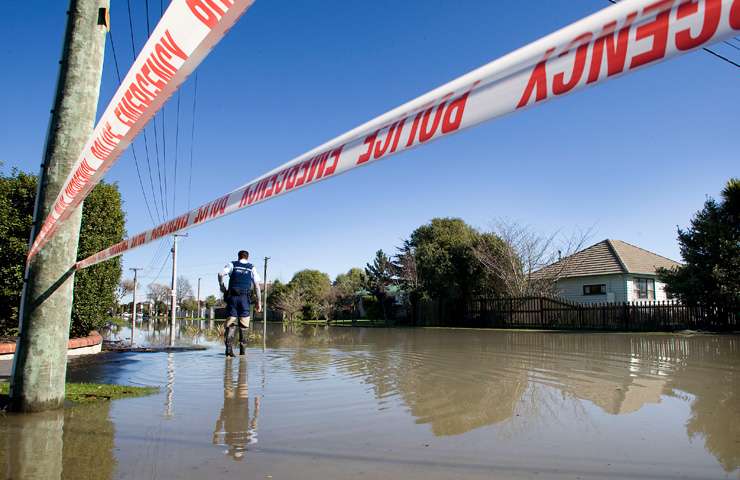 An Auckland family begins clearing flood-damaged property from their home. Photo / Getty Images