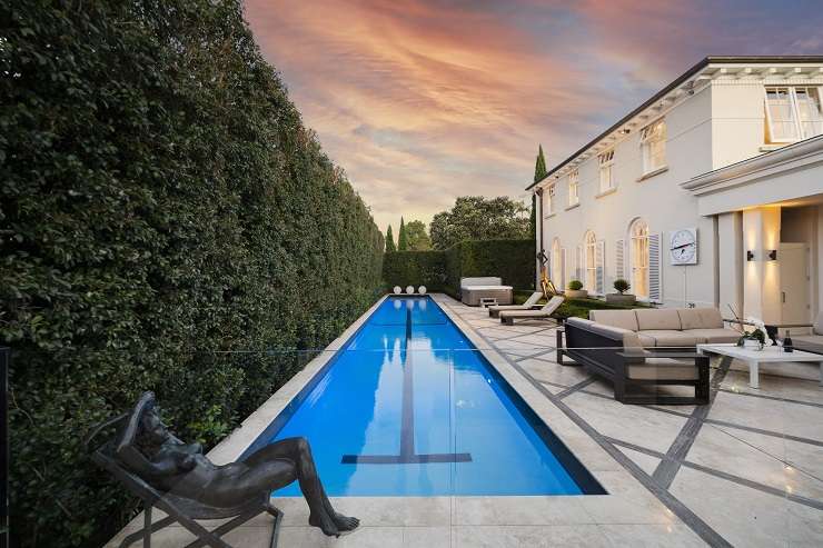 White tuscan-style mansion with cypress trees, lawn and clipped hedges 120 Victoria Avenue, Remuera