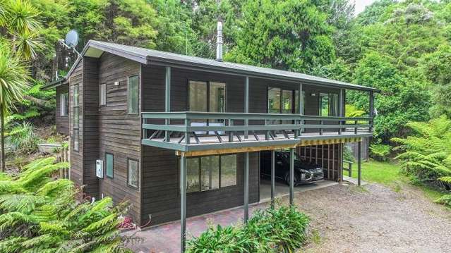 Two Auckland buyers in $1.4m auction scrap for bush retreat with sandy beach